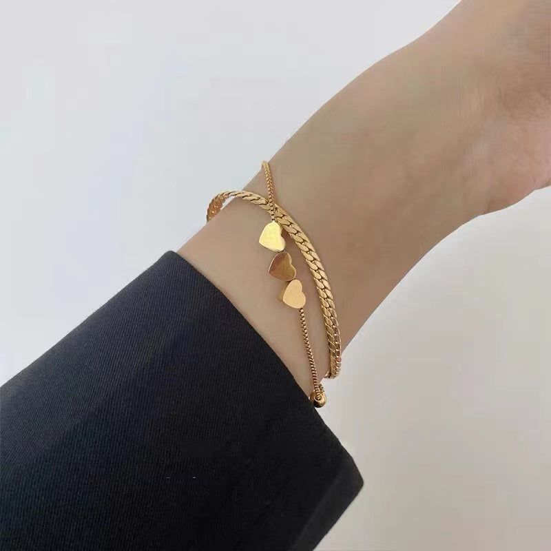 https://www.touchy-style.com/cdn/shop/products/stainless-steel-bracelets-charm-jewelry-xys1116-golden-double-layer-heart-shaped-touchy-style-2-32281091178691.jpg?v=1697951371